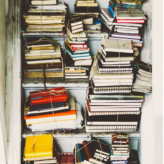 stack of old journals waiting to be upcycled