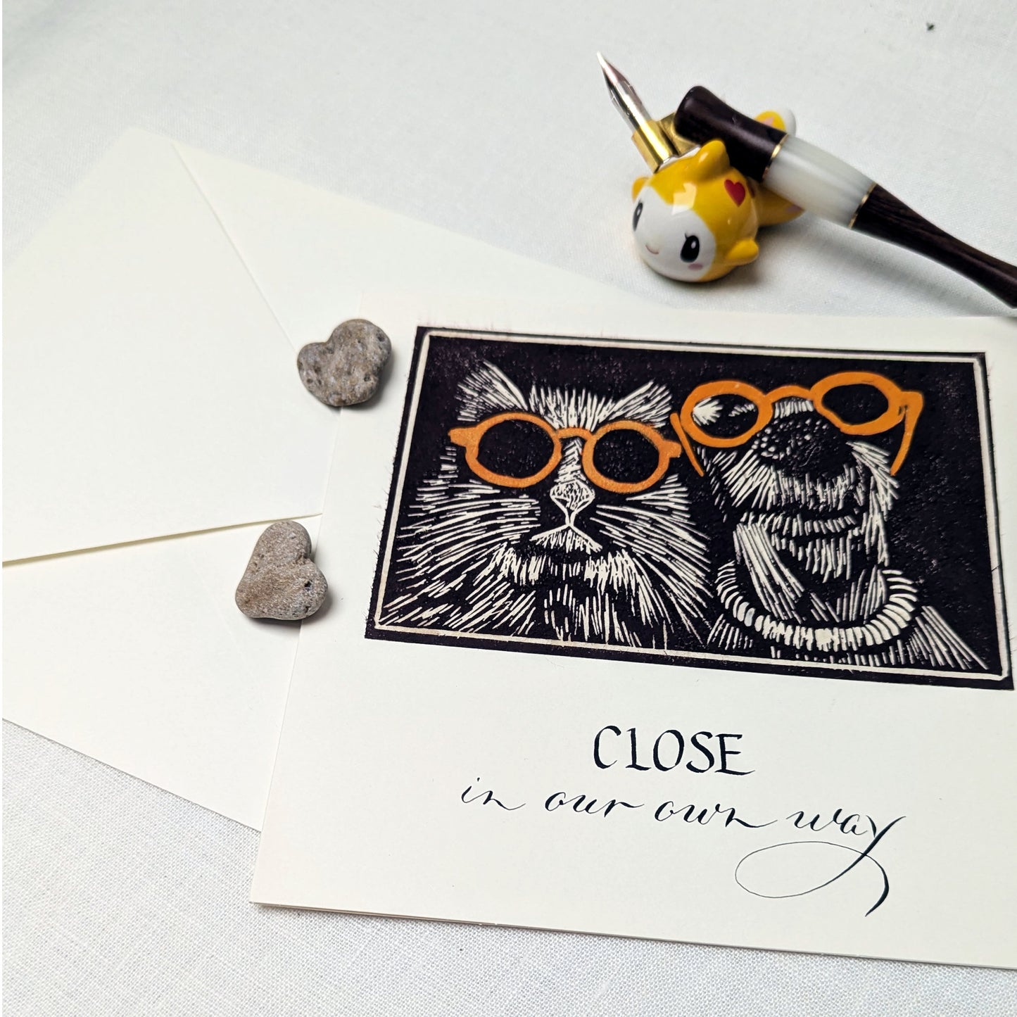 Some bonds don’t need fuss or fanfare. They’re simply… close, in their own way.

This handmade card celebrates togetherness with a soft sense of humour — perfect for couples, kindred spirits, long-term companions, or anyone who understands that closeness comes in many forms. The lino print illustration is hand-pulled, giving each card subtle variations and character, while the text is written individually using a traditional dip pen.