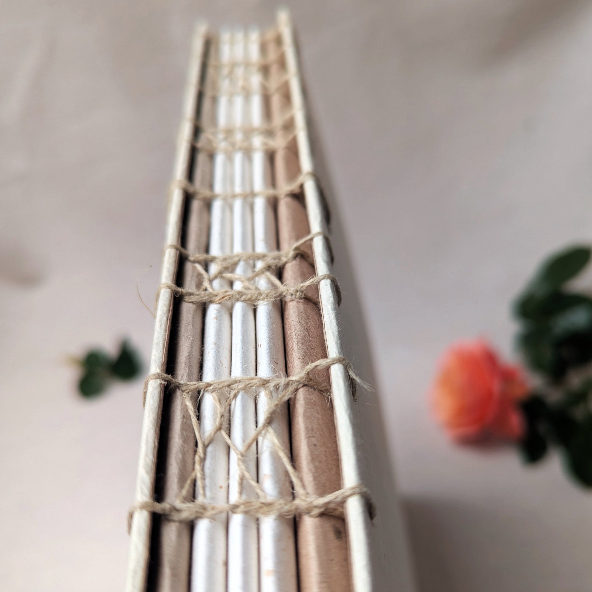 Close-up: Decorative French stitch binding using linen thread on artisanal photo album