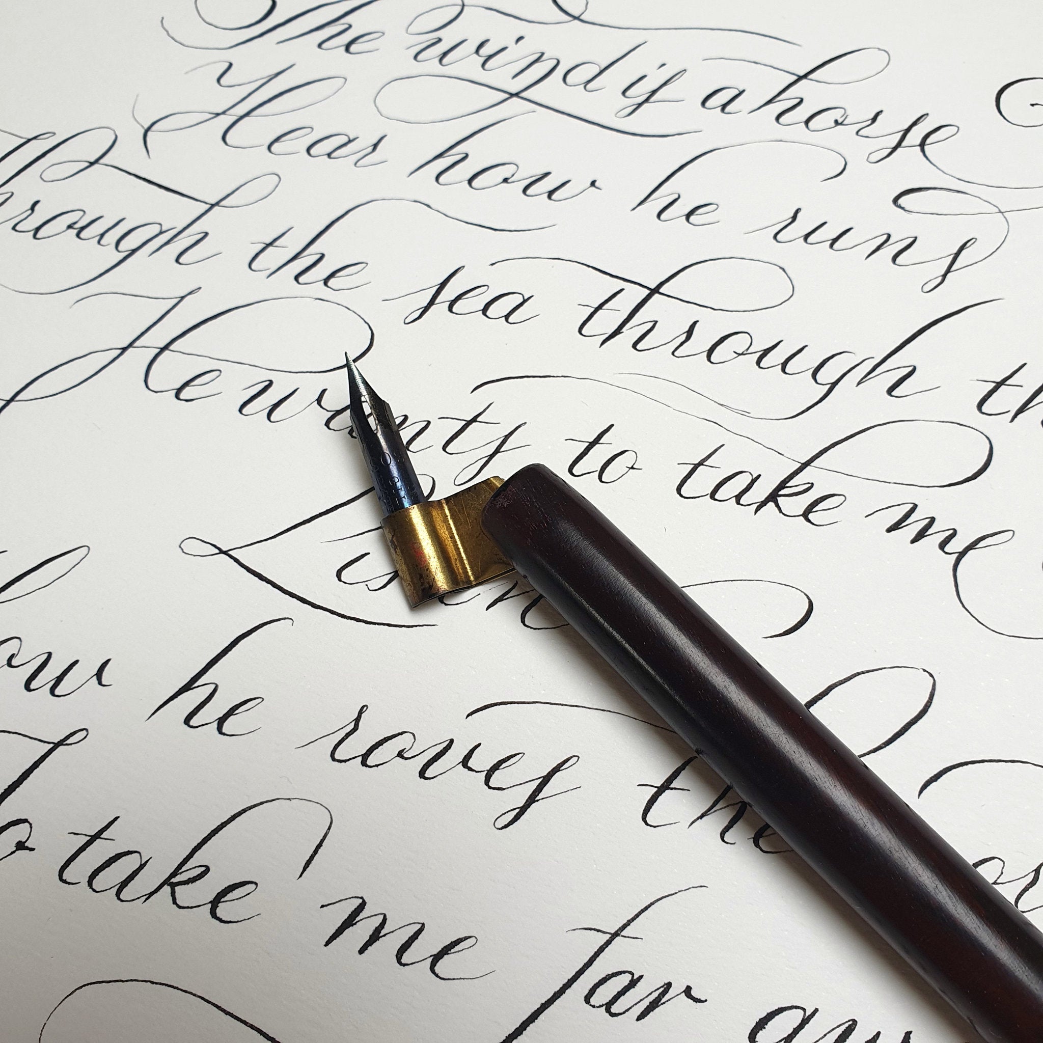 Dip pen resting on a completed handwritten Irish blessing